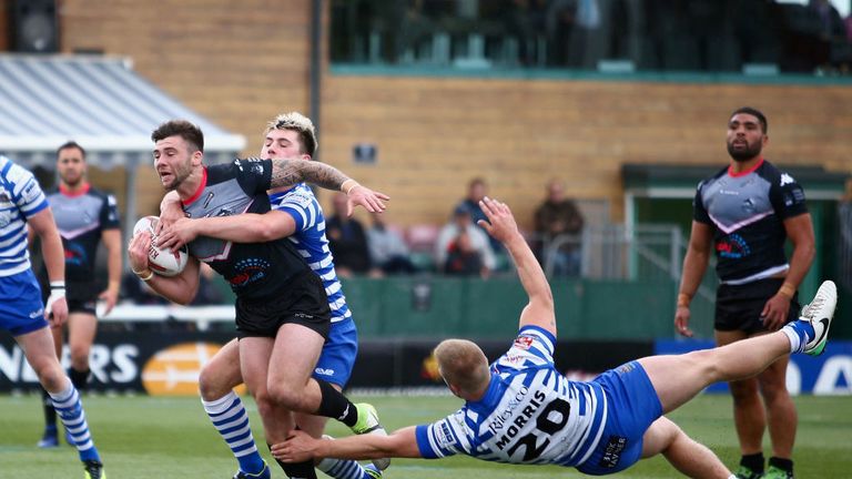 SEPTEMBER 10, 2017: Andy Ackers of London Broncos is tackled by James Saltonstall and Elliott Morris of Halifax during the Kingstone Press C'ship.