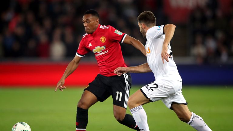 Manchester United's Anthony Martial (left) and Swansea City's Angel Rangel (right) battle for the ball