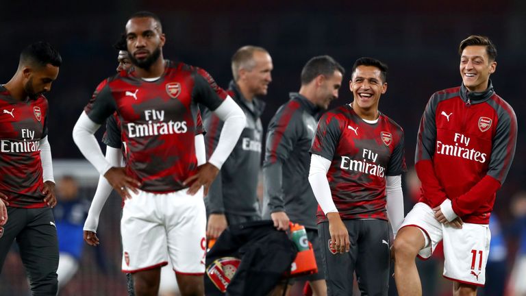 LONDON, ENGLAND - SEPTEMBER 25:  Alexis Sanchez and Mesut Ozil of Arsenal share a joke prior to the Premier League match between Arsenal and West Bromwich 