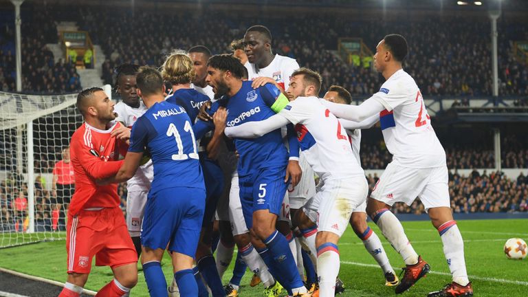 Ashley Williams (No 5) clashes with Lyon players after a challenge on Anthony Lopes (in orange) 