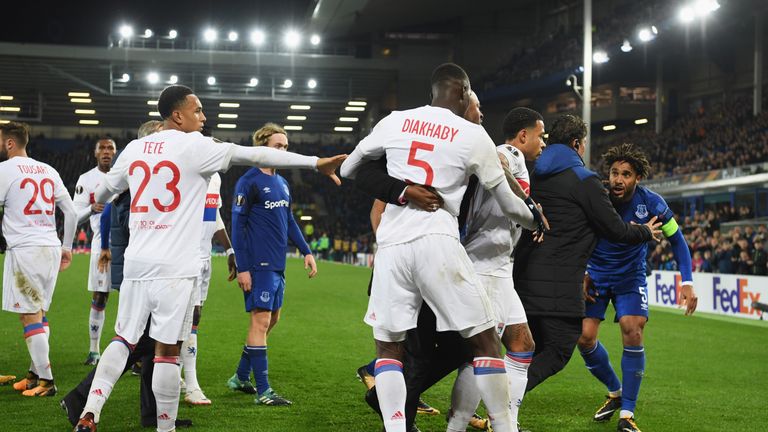 LIVERPOOL, ENGLAND - OCTOBER 19:  Ashley Williams of Everton (R) is restrained as he clashes with Lyon players after a challenge on Anthony Lopes of Lyon d