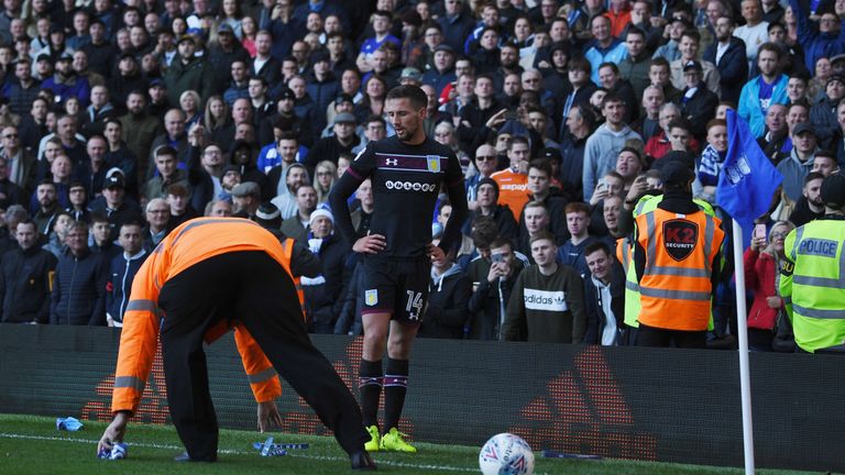Clappers are removed from the pitch as Conor Hourihane of Aston Villa prepares to take a corner