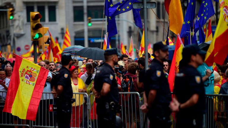 People hold Spanish flags during a demonstration against independence in Barcelona