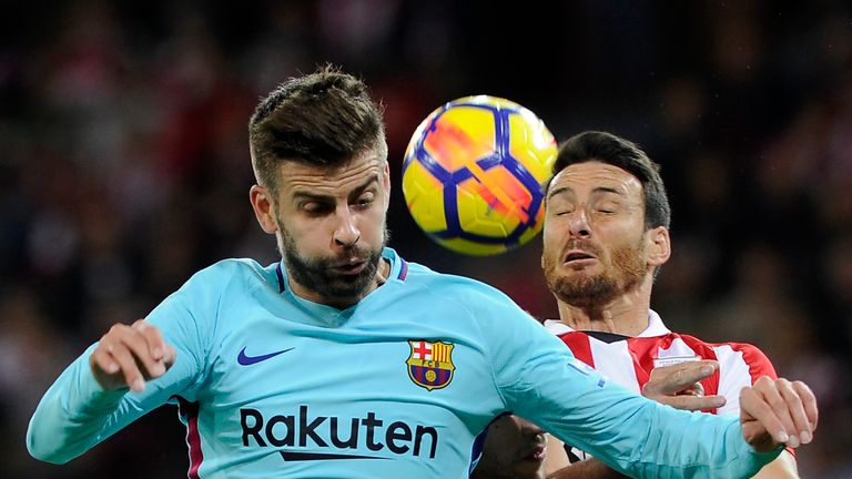 Barcelona defender Gerard Pique (L) vies with Athletic Bilbao forward Aritz Aduriz during the Spanish La Liga league football match