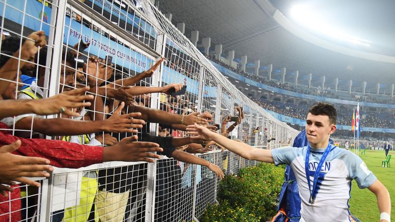 England's midfielder Phil Foden greets spectators after England's win over Spain in the final FIFA U-17 World Cup football match at the Vivekananda Yuba Bh