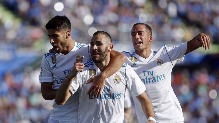 Karim Benzema (C) celebratesafter scoring Real Madrid's opening goal.