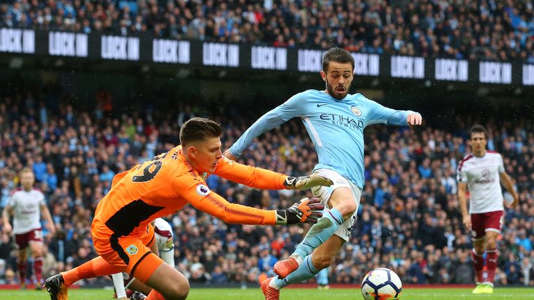 MANCHESTER, ENGLAND - OCTOBER 21:  Bernardo Silva of Manchester City is challenged by Nick Pope of Burnley to concede a penalty