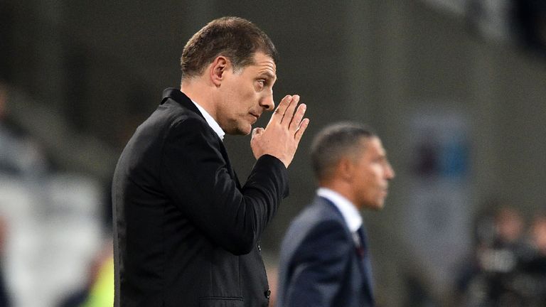 West Ham United's Croatian manager Slaven Bilic (L) and Brighton's Irish manager Chris Hughton watch from the touchline during the English Premier League f