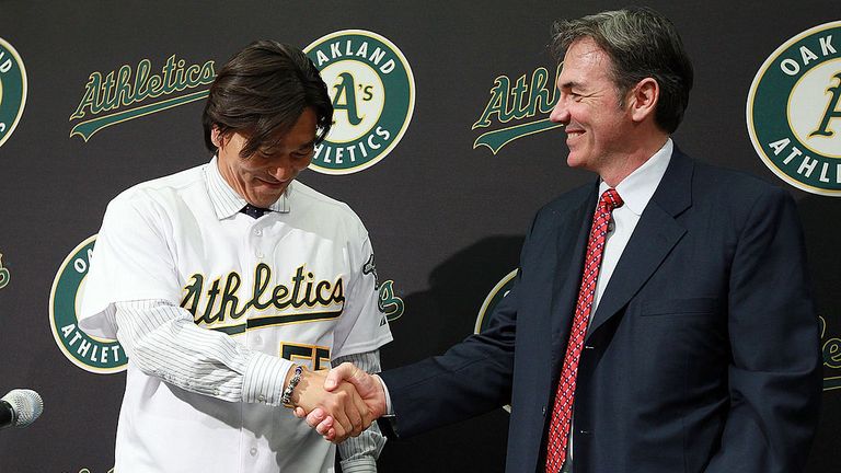OAKLAND, CA - DECEMBER 14:  Hideki Matsui (L) shakes hands with Oakland Athletics general manager Billy Beane (R) after trying on his new jersey during a p
