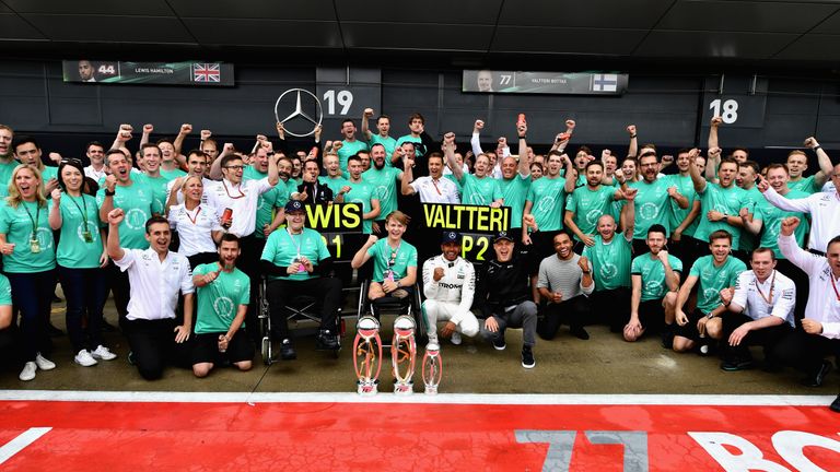 NORTHAMPTON, ENGLAND - JULY 16:  Race winner Lewis Hamilton of Great Britain and Mercedes GP celebrates with Valtteri Bottas of Finland and Mercedes GP, Bi