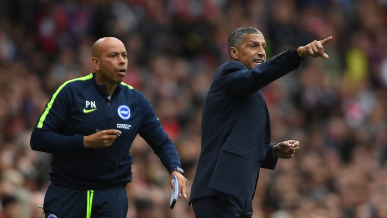 Brighton manager Chris Hughton and assistant Paul Nevin issue instructions during the Premier League match at Arsenal