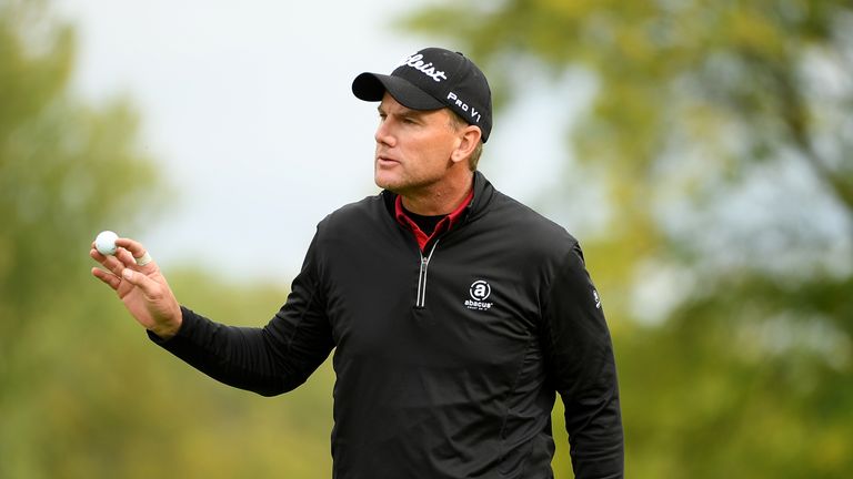 Robert Karlsson of Sweden acknowledges the crowd after holing out on the 11th hole during day four of the British Masters