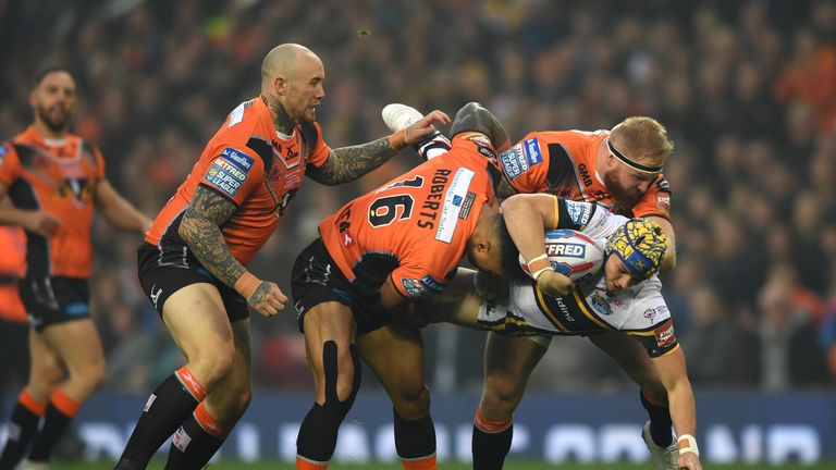 MANCHESTER, ENGLAND - OCTOBER 07:  Jack Walker of Leeds Rhinos is tackled by Ben Roberts of Castleford Tigers during the Betfred Super League Grand Final m