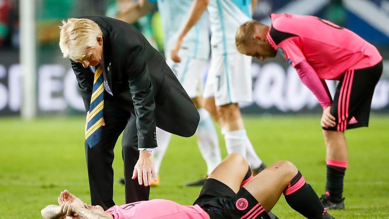 LJUBLJANA, SLOVENIA - OCTOBER 08: Head coach Gordon Strachan (top) comforts Leigh Griffiths of Scotland after the FIFA 2018 World Cup Qualifier match betwe