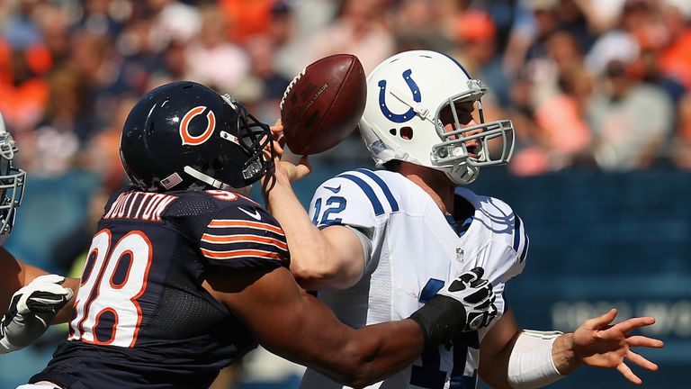 CHICAGO, IL - SEPTEMBER 09: Andrew Luck #12 of the Indianapolis Colts fumbles the ball as he is hit by Corey Wootton #98 of the Chicago Bears during their 