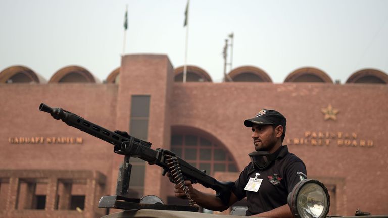 A Pakistani policeman stands guard outside the Gaddafi Cricket Stadium