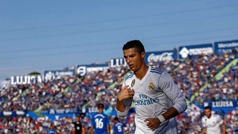 Real Madrid's Portuguese forward Cristiano Ronaldo crosses himself to celebrate his team's second goal during the Spanish league football match Getafe CF v