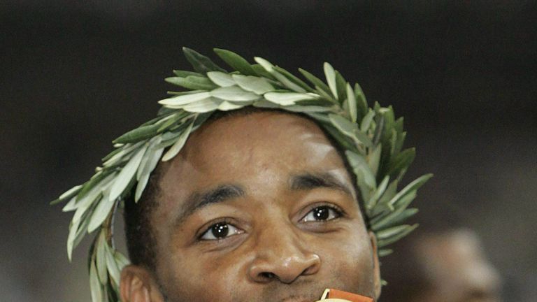 Darren Campbell kisses his gold medal after the British team won the Men's 4 x 100m Relay final at the 2004 Athens Olympic Games