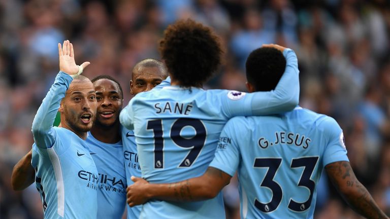 MANCHESTER, ENGLAND - OCTOBER 14: David Silva of Manchester City celebrates scoring his sides third goal with his Manchester City team mates during the Pre