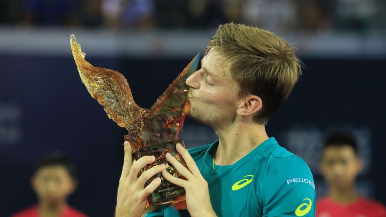 David Goffin of Belgium poses with the trophy after defeating Alexandr Dolgopolov of Ukraine during the ATP Shenzhen Open