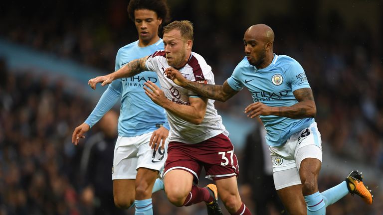 Scott Arfield of Burnley takes on Leroy Sane and Fabian Delph of Manchester City during the Premier League match 