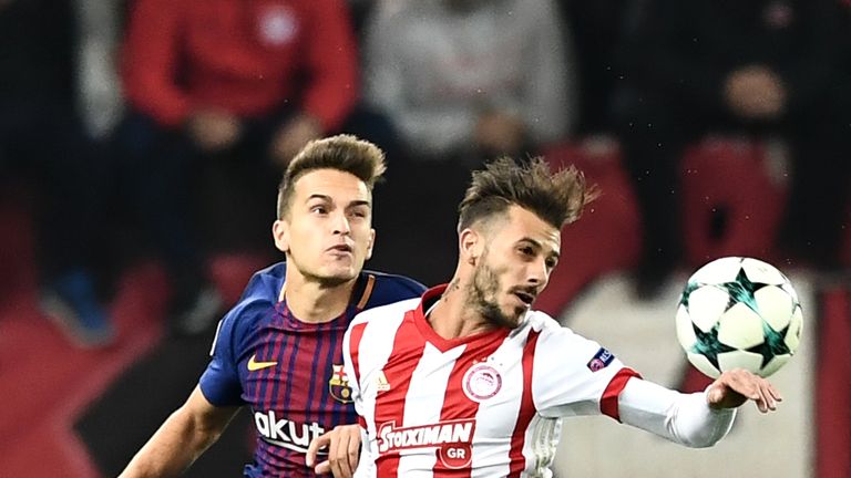 Barcelona's Denis Suarez (L) vies with Olympiakos' Diogo Figueiras during the UEFA Champions League group D match