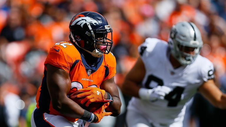 DENVER, CO - OCTOBER 1:  Running back C.J. Anderson #22 of the Denver Broncos rushes against the Oakland Raiders in the first quarter of a game at Sports A