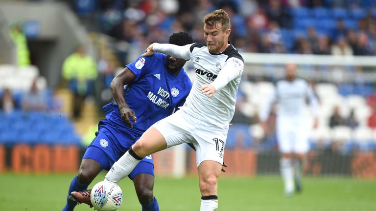 Cardiff City's Bruno Ecuele Manga and Derby County's Sam Winnall battle for the ball during the Sky Bet Championship match at Cardiff City Stadium
