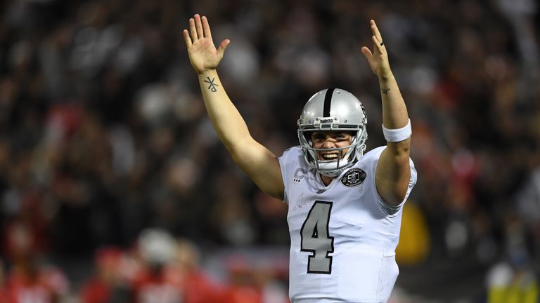 OAKLAND, CA - OCTOBER 19:  Derek Carr #4 of the Oakland Raiders celebrates after a touchdown by DeAndre Washington #33 against the Kansas City Chiefs durin