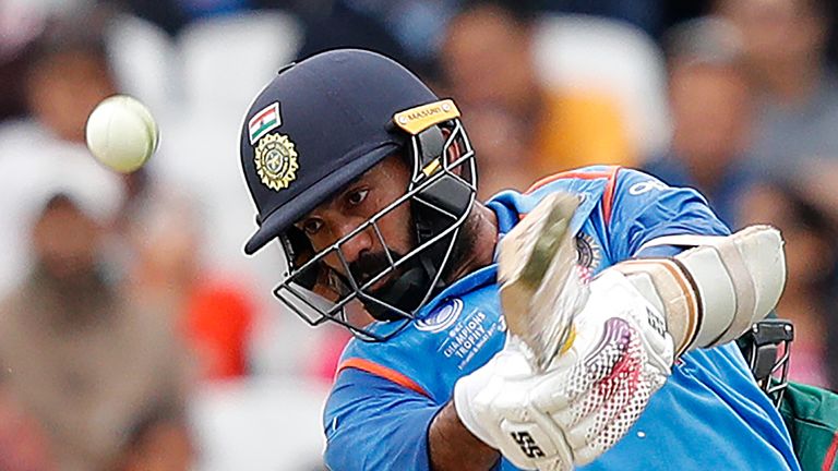 India's Dinesh Karthik plays shot for four runs during the ICC Champions Trophy Warm-up cricket match between India and Bangladesh at The Oval in London on