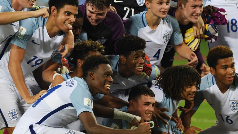 Members of the England team celebrate after winning the semifinal football match against Brazil in the FIFA U-17 World Cup at the Vivekananda Yuba Bharati 