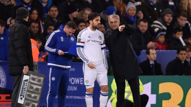 Cesc Fabregas of Chelsea speaks with Jose Mourinho the manager of Chelsea as he prepares to come on as a substitute 