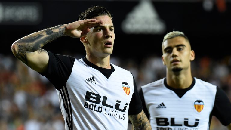 Valencia's forward Santi Mina (L) celebrates after scoring a goal during the Spanish league football match Valencia CF vs Sevilla FC at the Mestalla stadiu