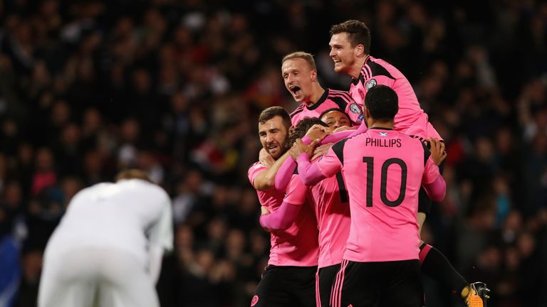 GLASGOW, SCOTLAND - OCTOBER 05:  Scotland players celebrate as Martin Skrtel of Slovakia scores an own goal for their first goal during the FIFA 2018 World