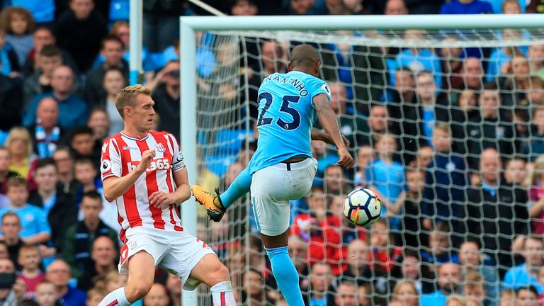 Manchester City's Brazilian midfielder Fernandinho (R) scores their fifth goal during the English Premier League football match between Manchester City and