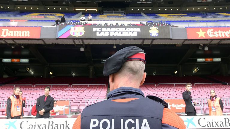 A police officer stands in front of empty stands after the decision to play Barcelona-Las Palmas behind closed doors