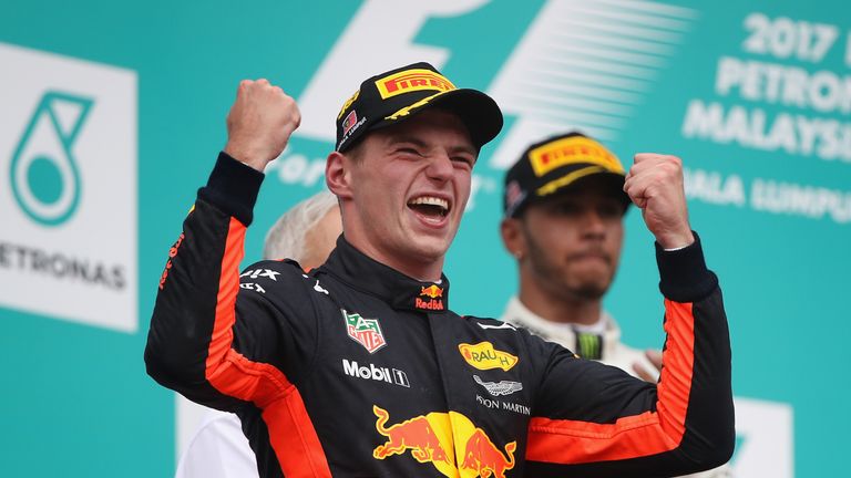 Race winner Max Verstappen celebrates on the podium in Sepang