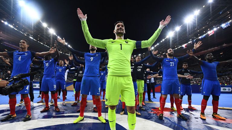 France's players celebrate with the thunderclap in front of their fans in Paris