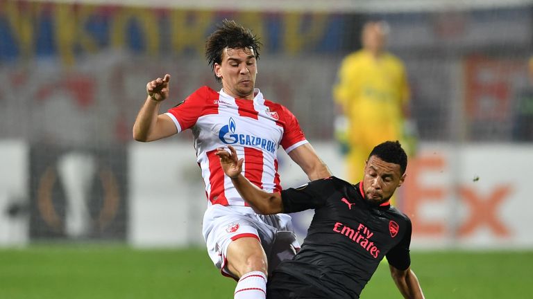 Filip Stojkovic (L) vies with Arsenal's midfielder Francis Coquelin 