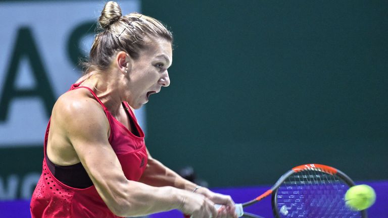 Simona Halep of Romania hits a return against Elina Svitolina of Ukraine during the WTA Finals tennis tournament in Singapore on October 27, 2017. / AFP PH