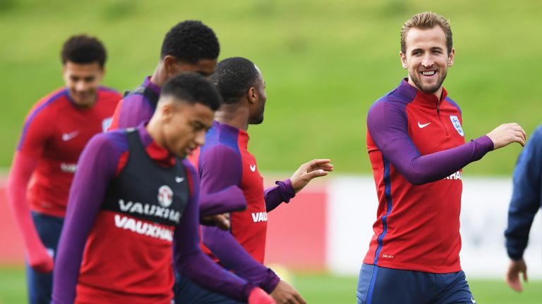 Harry Kane talks with England team-mate Raheem Sterling during a training session at St George's Park