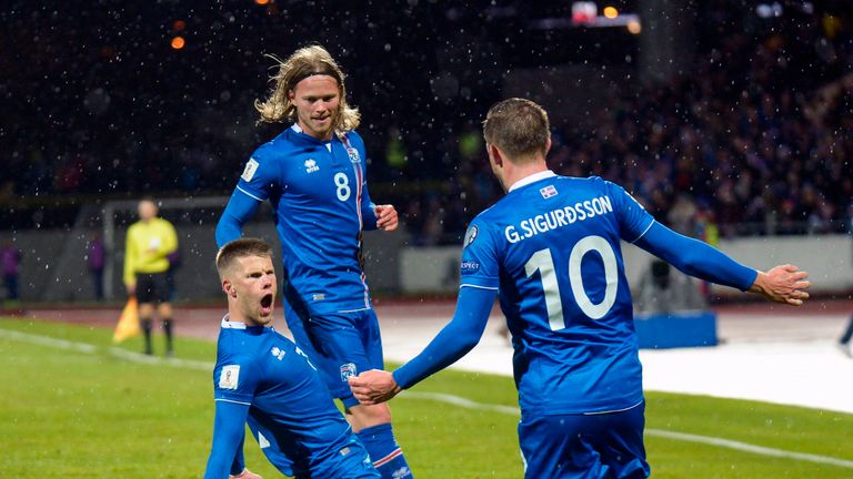 Iceland's forward Johann Berg Gudmundsson (L) celebrates scoring with his team-mates Iceland's midfielder Birkir Bjarnason (C) and Iceland's midfielder Gyl