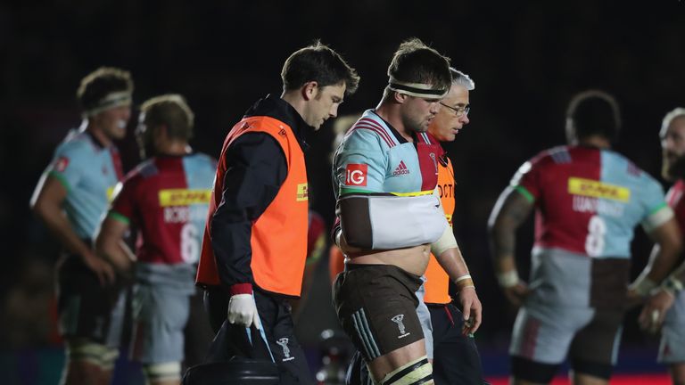 Jack Clifford of Harlequins is helped off the pitch
