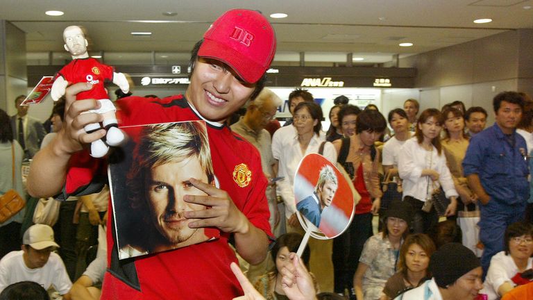 Japanese football fans wait for the arrival of football superstar David Beckham at Narita's New Tokyo International Airport, 18 June 2003.