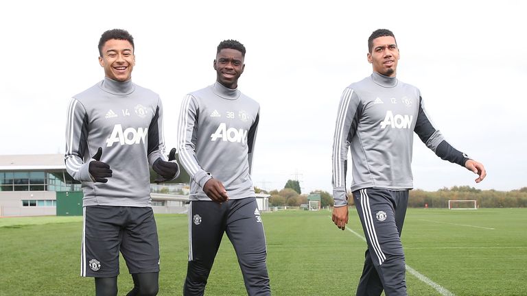 Jesse Lingard, Axel Tuanzebe and Chris Smalling make their way to first team training