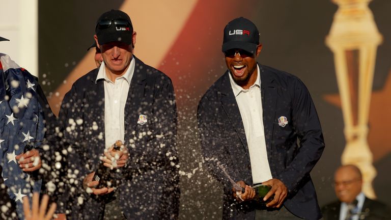 CHASKA, MN - OCTOBER 02: Vice-captains Jim Furyk and vice-captain Tiger Woods of the United States spray champagne after winning the Ryder Cup during the c