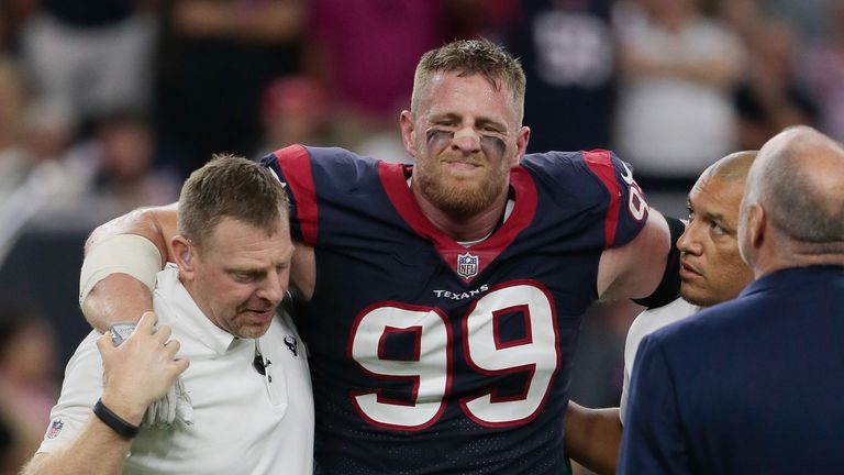 HOUSTON, TX - OCTOBER 08:  J.J. Watt #99 of the Houston Texans is helped off the field after being injured in the first quarter against the Kansas City Chi