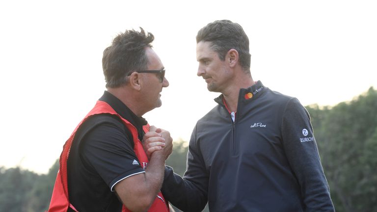 World Justin Rose of England shakes hands with his caddy after he stormed back from eight shots behind overnight to win the 9.75 million USD WGC-HSBC Champ