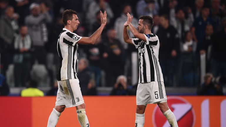 Juventus' forward from Croatia Mario Mandzukic (L) celebrates with Juventus midfielder Miralem Pjanic after scoring during the UEFA Champions League Group 