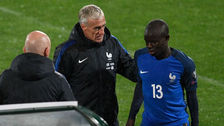 N'golo Kante is comforted by France's coach Didier Deschamps